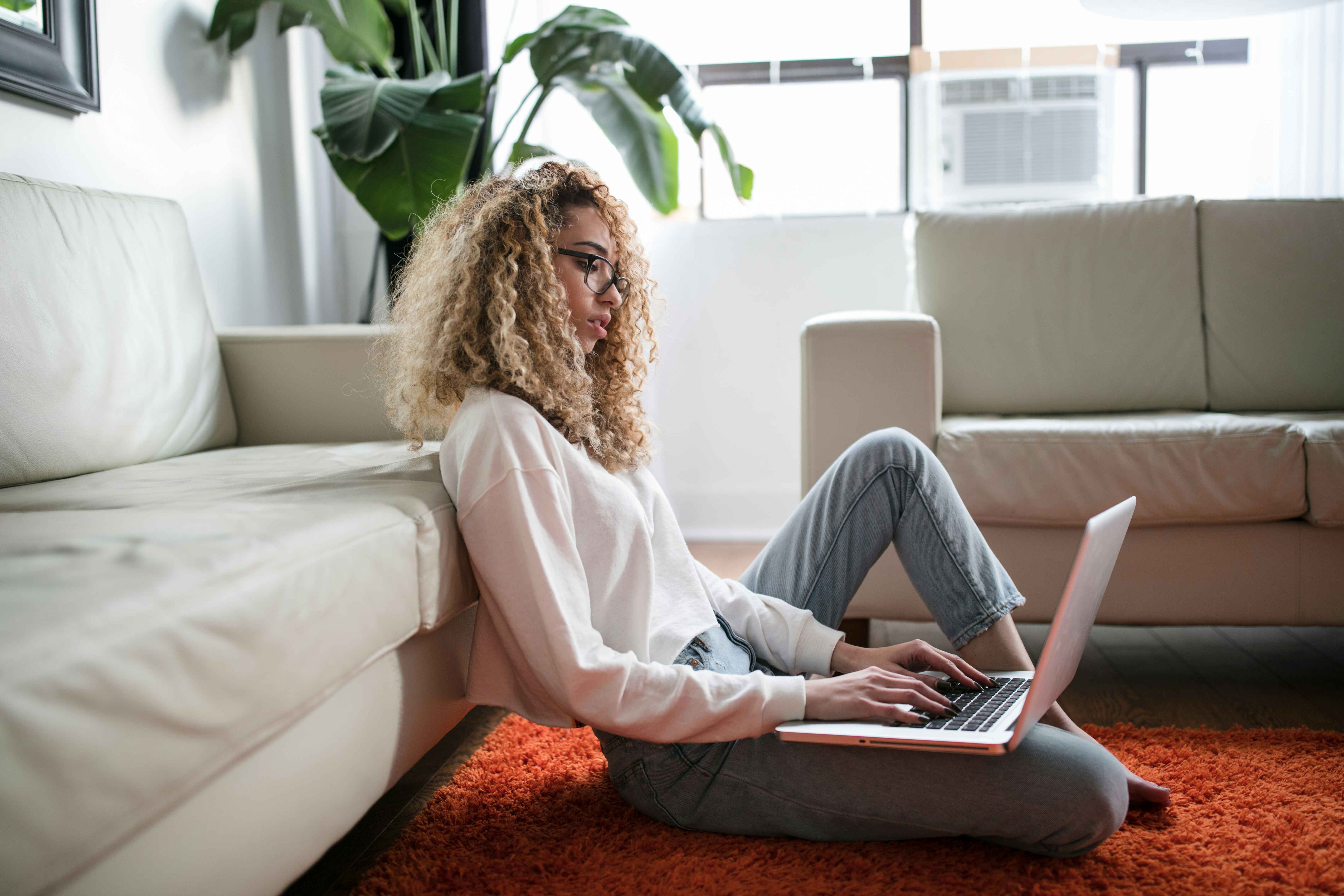 a-woman-sit-on-the-floor-using-a-laptop